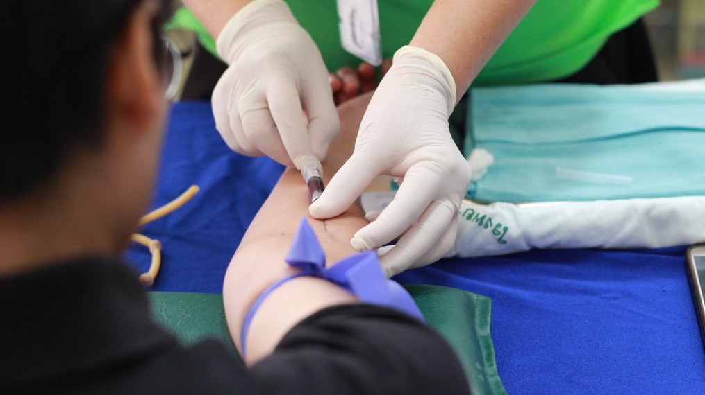 doctor injecting a patient